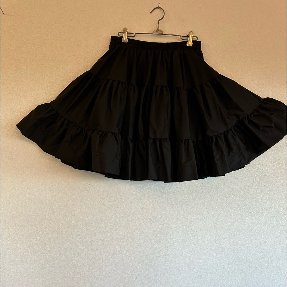 Black 3-tiered skirt with 26”elastic waist when relaxed. Length 19 1/2”.